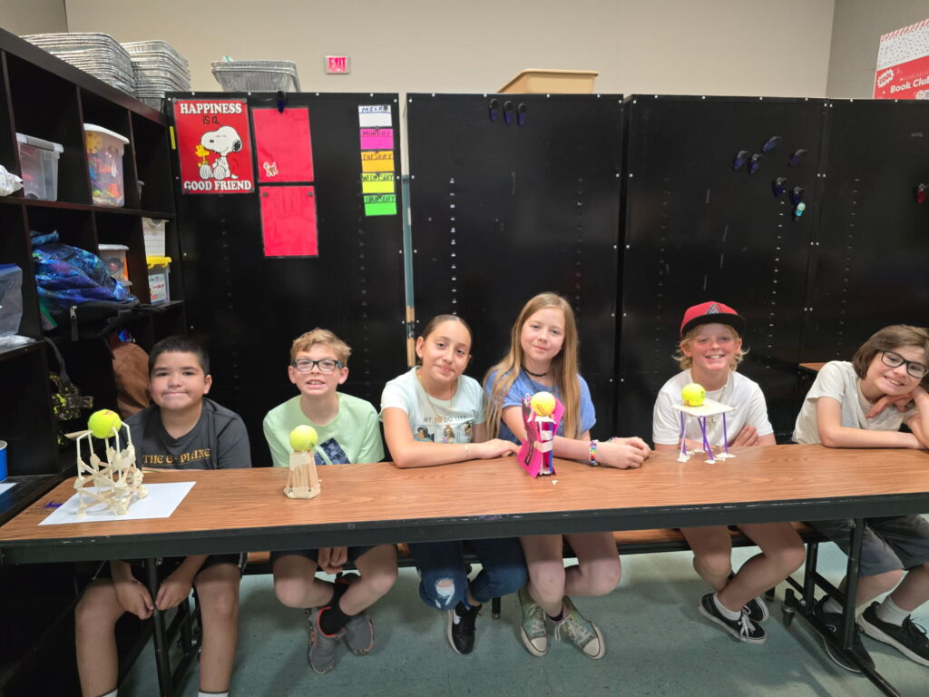 Students at EDUPRIZE Gilbert working on a group STEM project with hands-on science tools in a classroom.