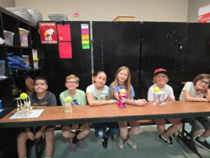 Students at EDUPRIZE Gilbert working on a group STEM project with hands-on science tools in a classroom.