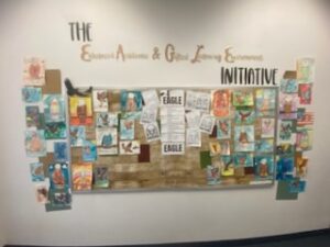 Smiling students and teachers at EDUPRIZE Queen Creek during a class activity, reflecting a positive school culture with small class sizes and community values.