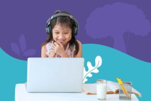 A student in Arizona attends a live virtual class at home with headphones and a laptop, learning through EDUPRIZE Online.