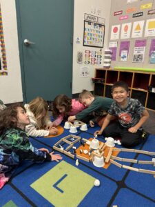 Students at EDUPRIZE Gilbert working on a hands-on science experiment in a Cottage-themed classroom.