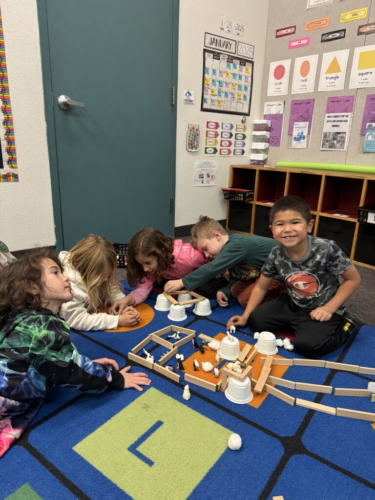 Students at EDUPRIZE Gilbert working on a hands-on science experiment in a Cottage-themed classroom.