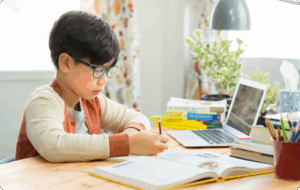 An EDUPRIZE Online student learning from home on a laptop with interactive class content.