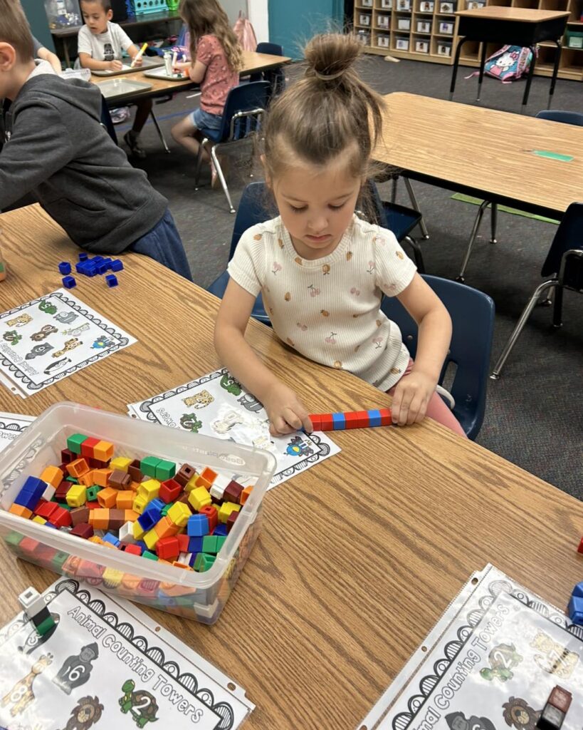 Kindergarten student learning with teacher at EDUPRIZE